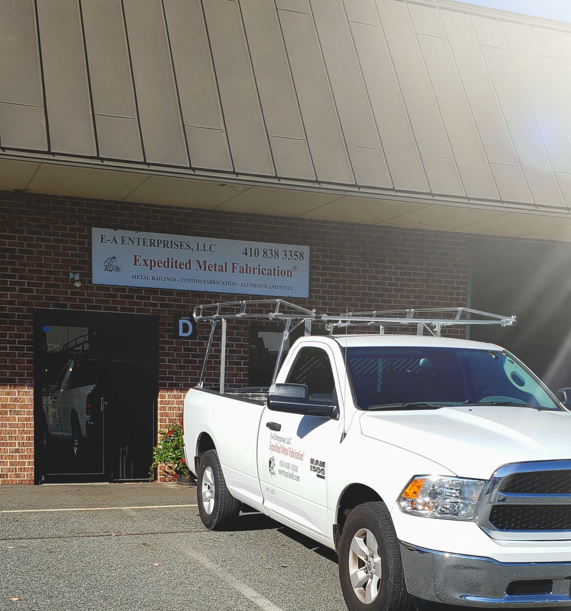 Exterior of the E-A Enterprises LLC building with a sign stating Expedited Metal Fabrication and the phone number 410-838-3358