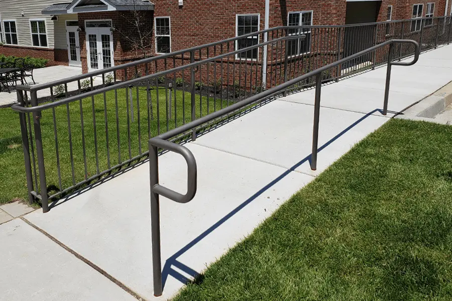Photo of gray commmercial railing on an outdoor ramp
