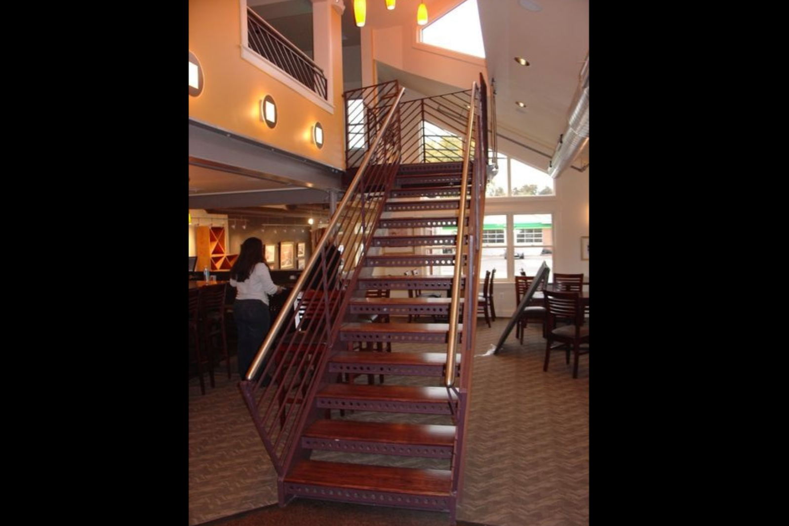 Photo of reddish-brown commercial railing inside a restaurant 
