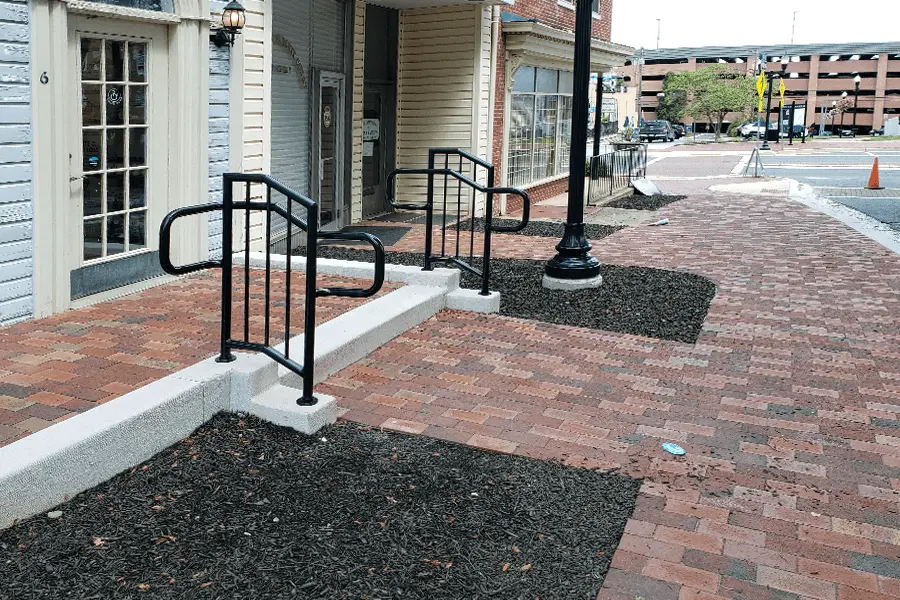 Photo of black welded commercial railing for an outdoor step
