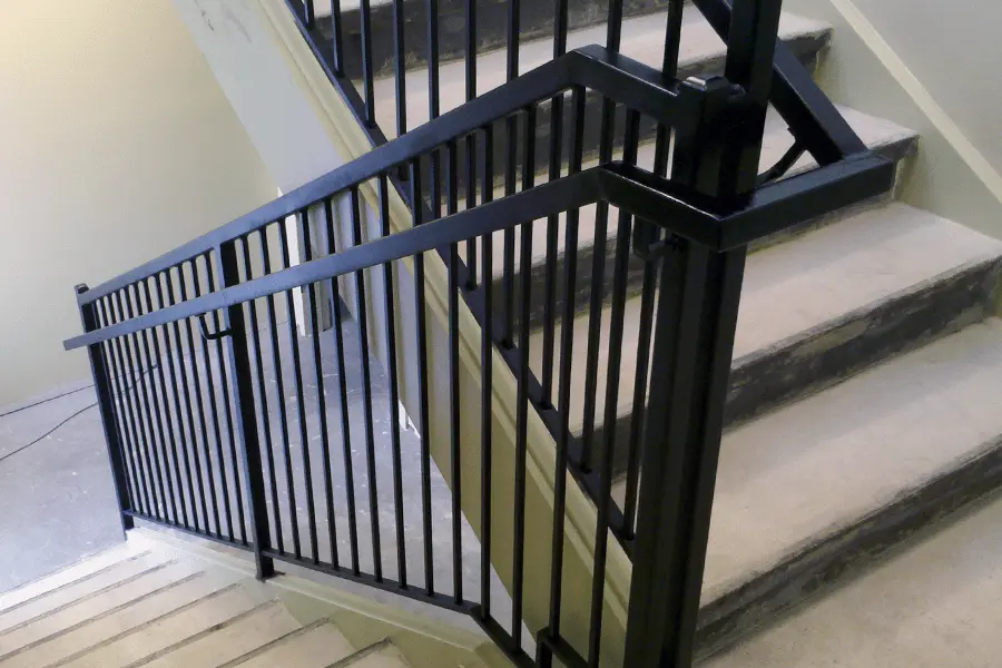 Photo of welded black metal commercial railing for indoor staircase