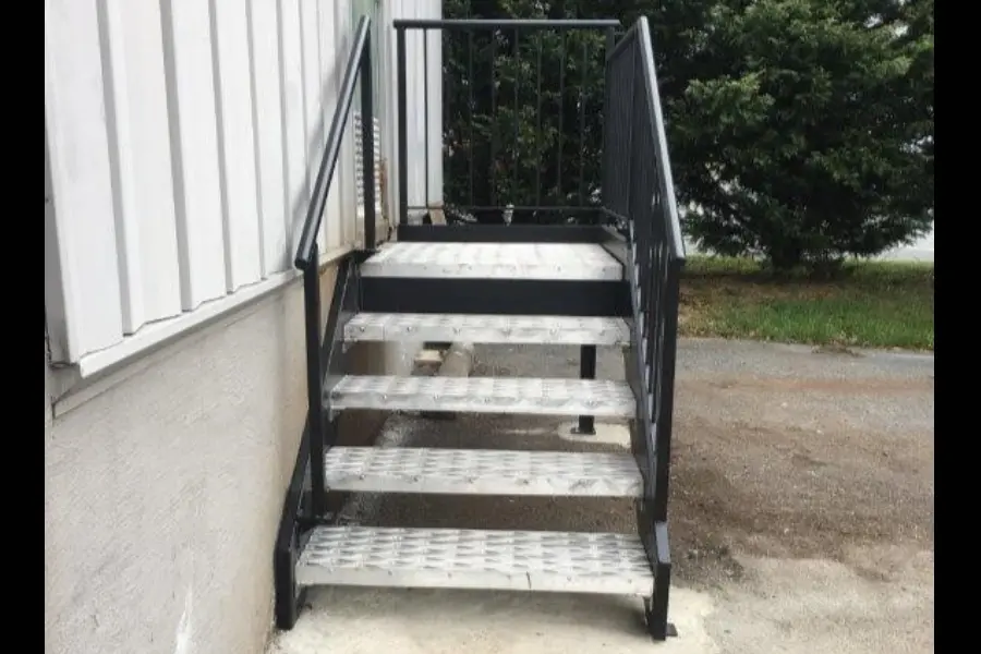 Photo of black metal commercial railing for outdoor staircase with silver metal stairs and black framing