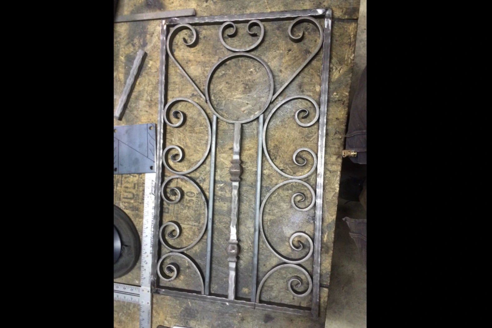 Photo of grey decorative metalwork resting on a work table