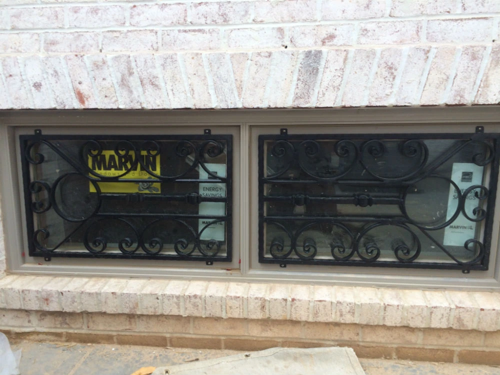 Photo of black metal window bar decorations mounted on newly installed windows