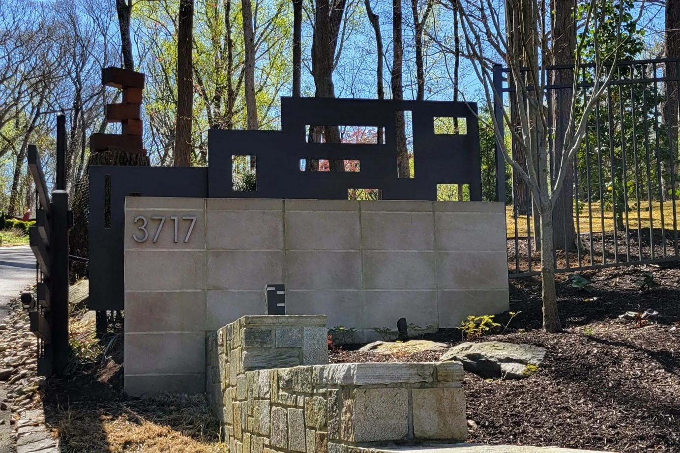 Photo of modern grey decorative metalwork beside a driveway