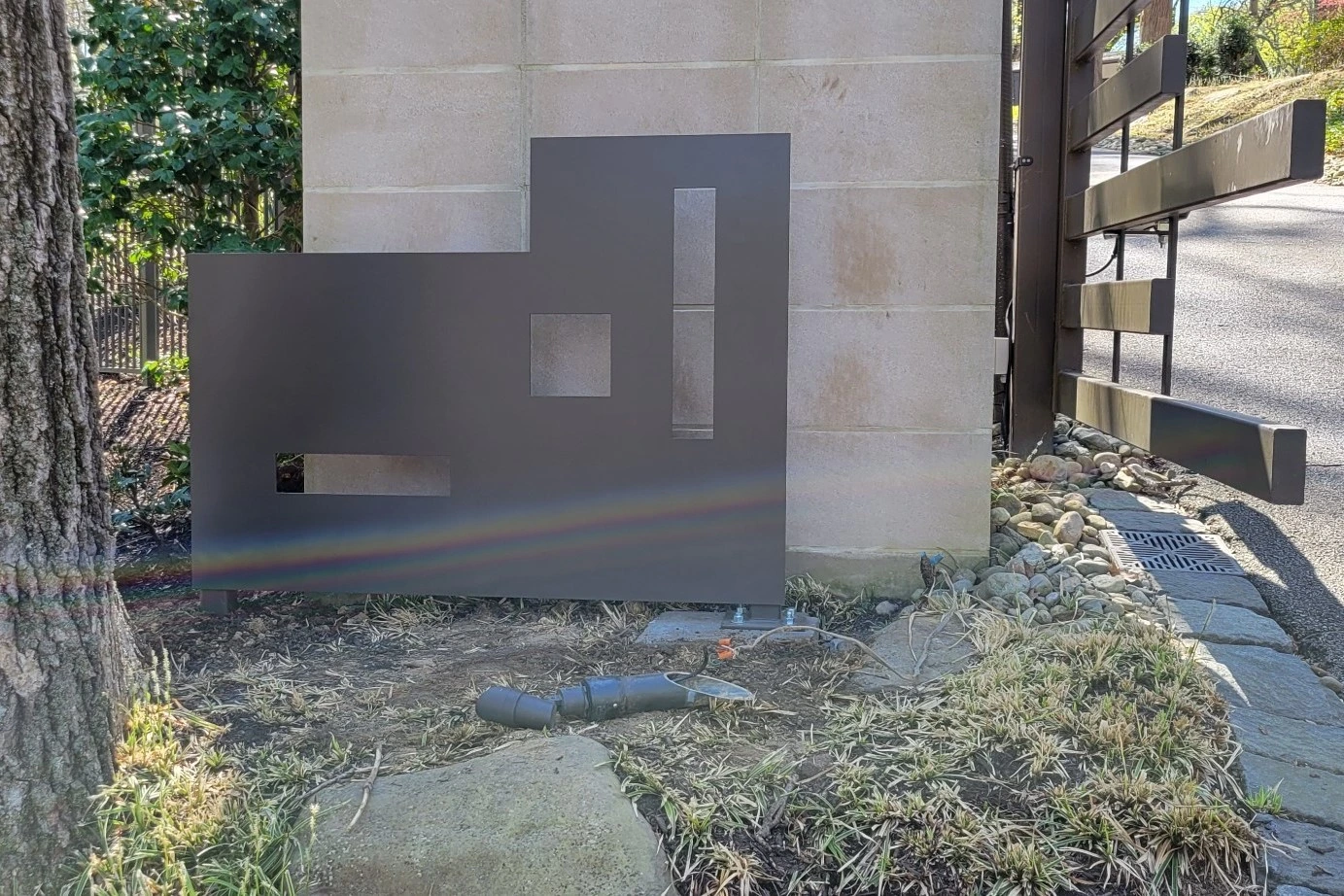 Photo of modern grey decorative metalwork with rectangles cut into the design