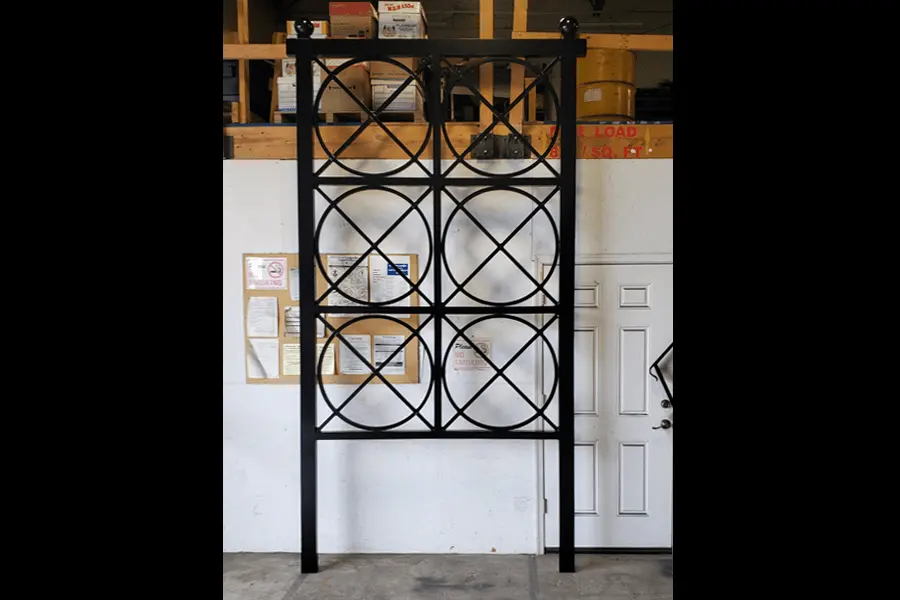 Photo of black decorative welded metal made of six boxes stacked two across and three high with a circle and an 'x' in each box 