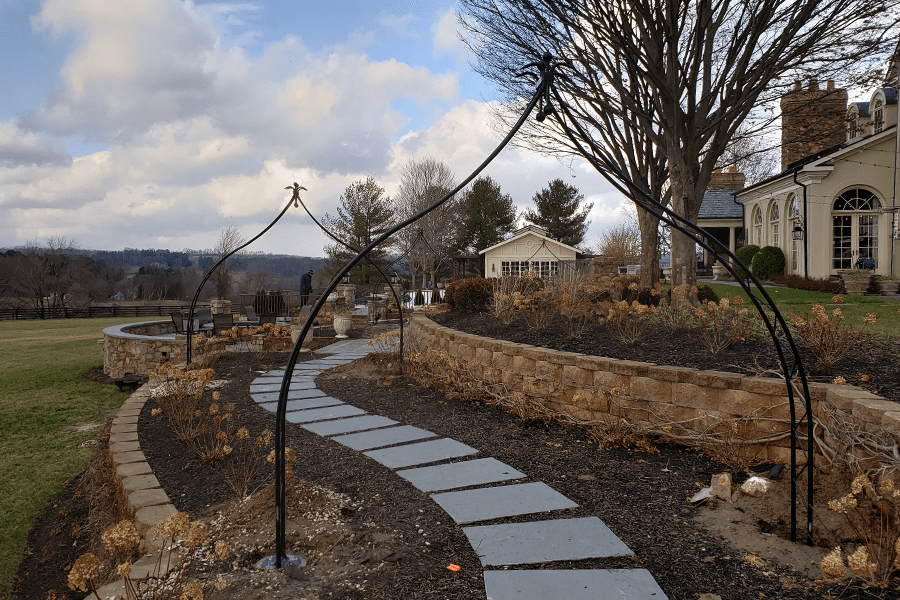 Decorative black fence gate for an outdoor sitting area