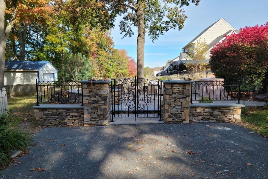 Decorative black fence gate for an outdoor sitting area