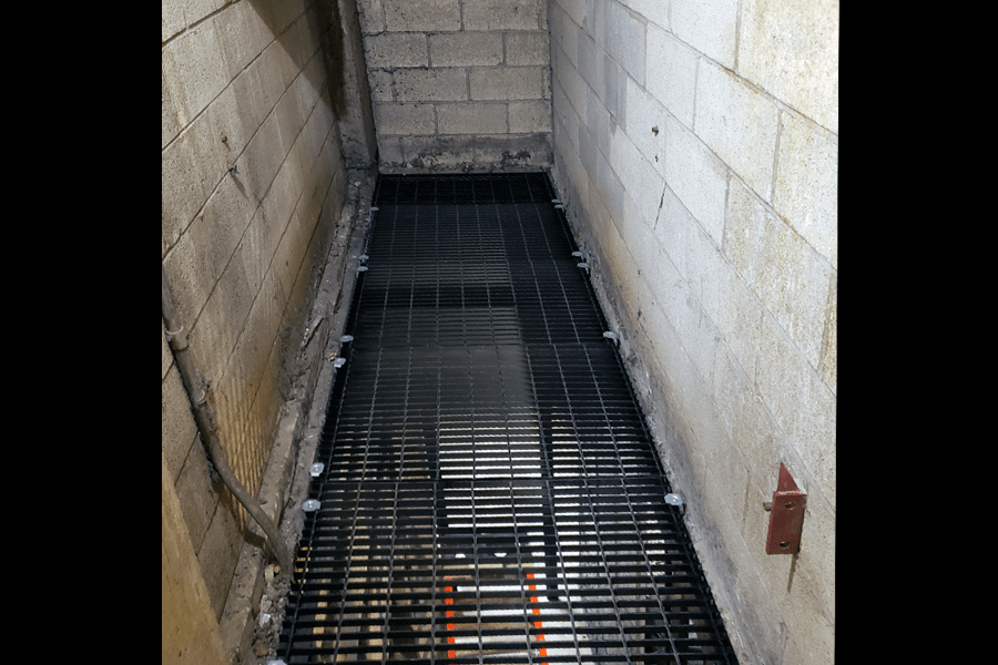 Photo of black custom metal grating over a room