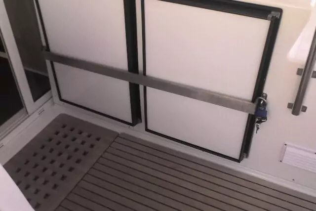 Photo of a welded grey metal bar used for locking a cabinent