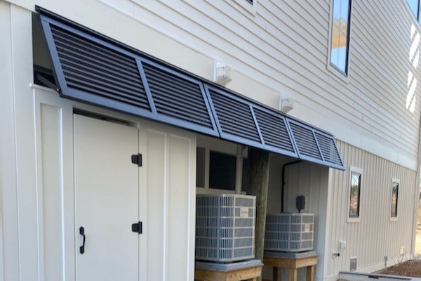 Black metal bahama shutters for a beachfront property