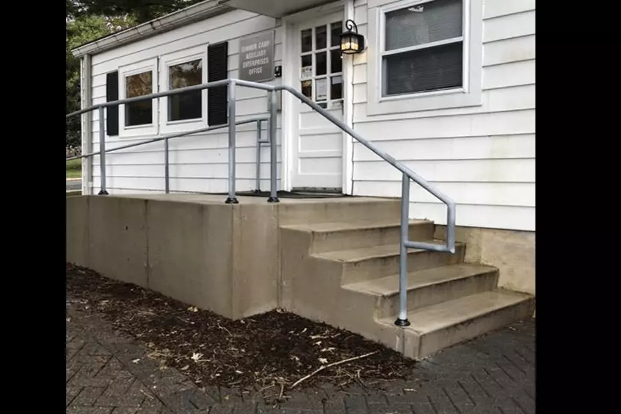 Photo of gray pipe railing outside of camp office