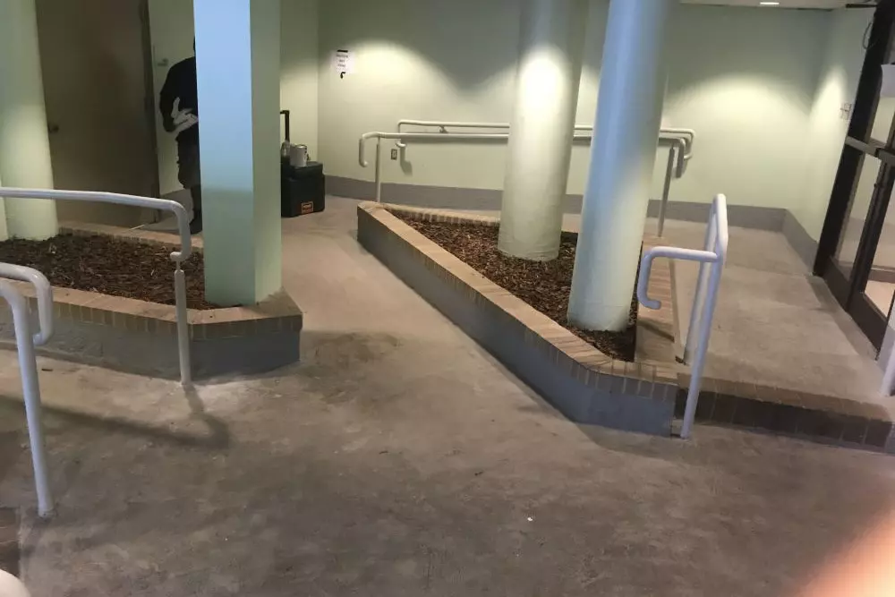 Photo of white-grey metal pipe railing around a series of walkways