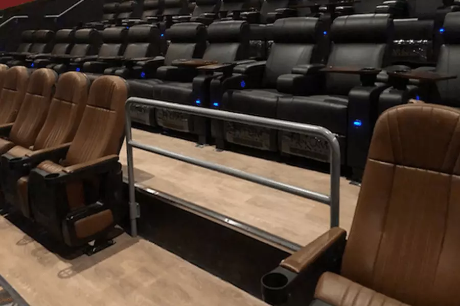 Photo of guard pipe railing in a movie theater