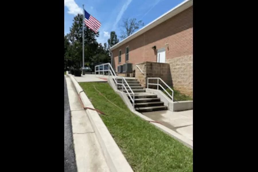 Photo of pipe railing spanning multiple levels of stairs outdoors