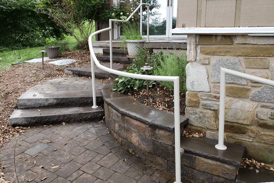 Photo of white pipe railing for an outdoor staircase