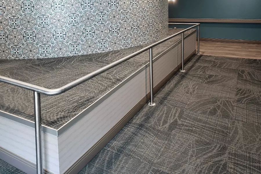 Photo of silver pipe railing wrapping around a corner indoors