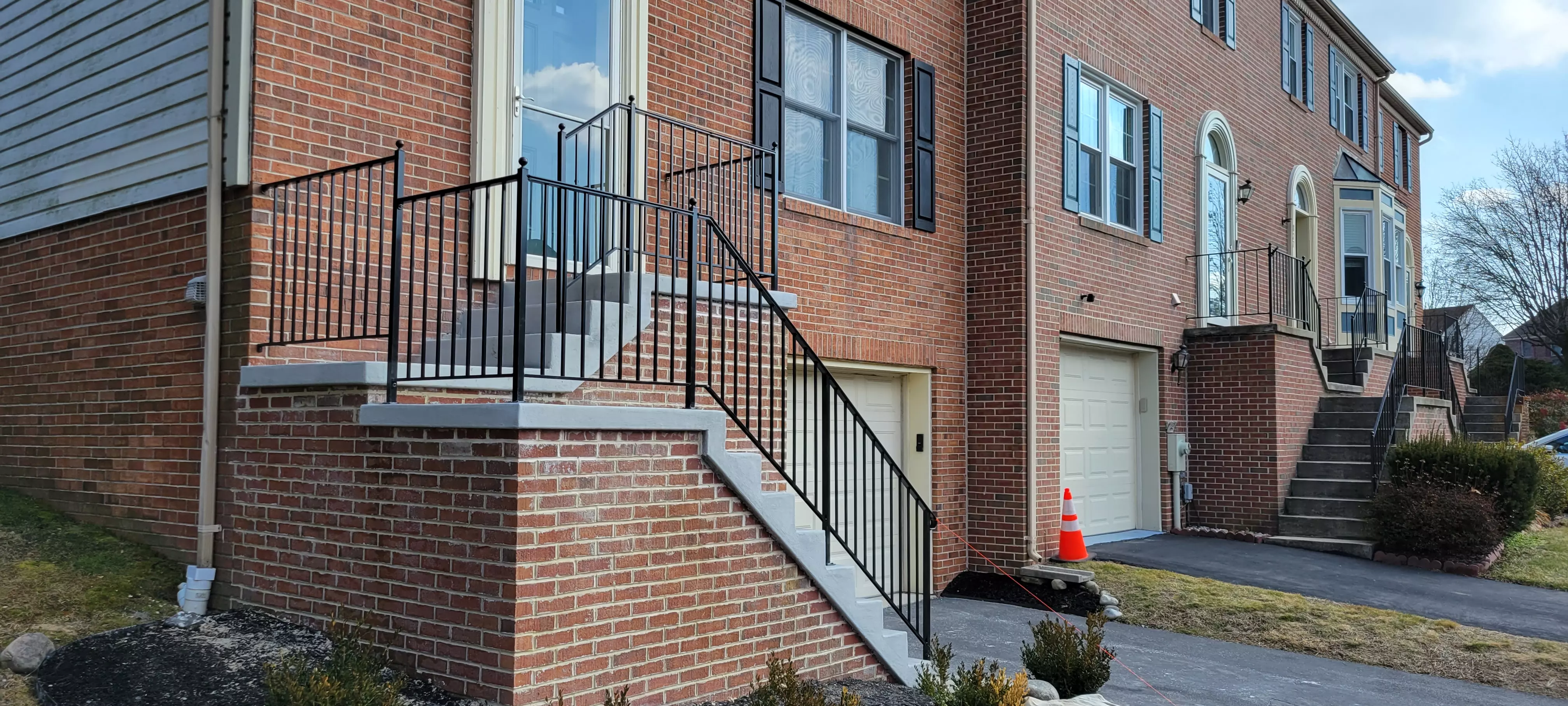 Photo of black residential railing on an outdoor staircase