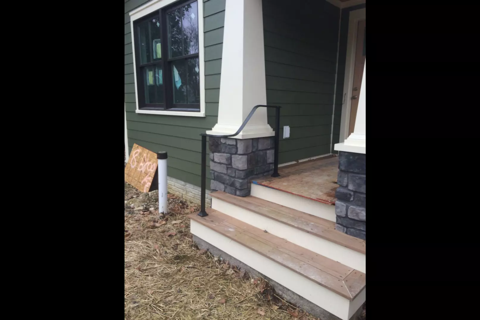 Photo of black metal curved railing for outdoor porch steps