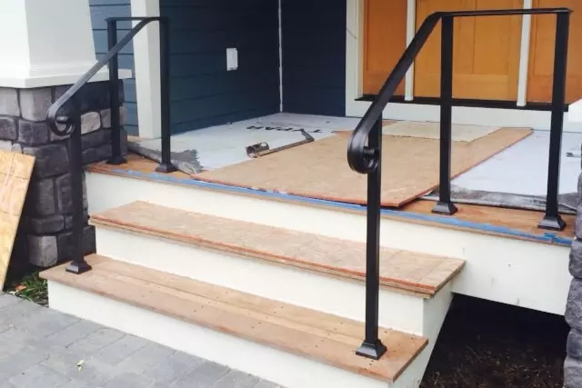 Photo of welded black metal railing for outdoor residential staircase