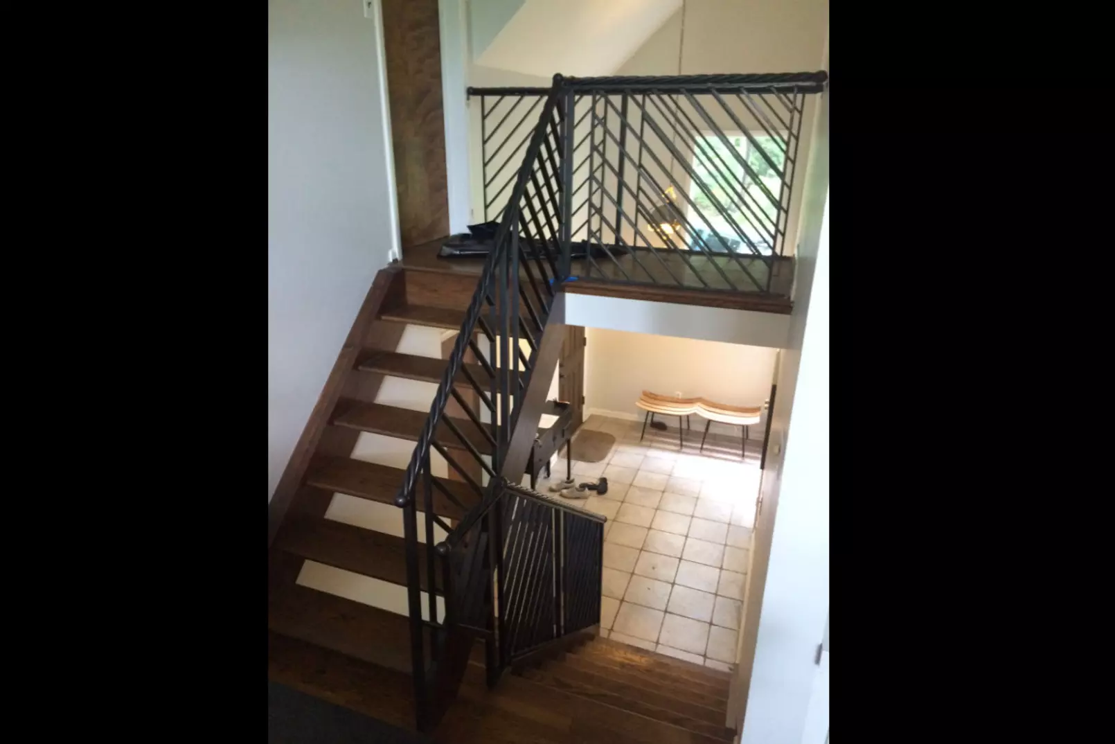 Photo of indoor black metal railing on wooden staircase