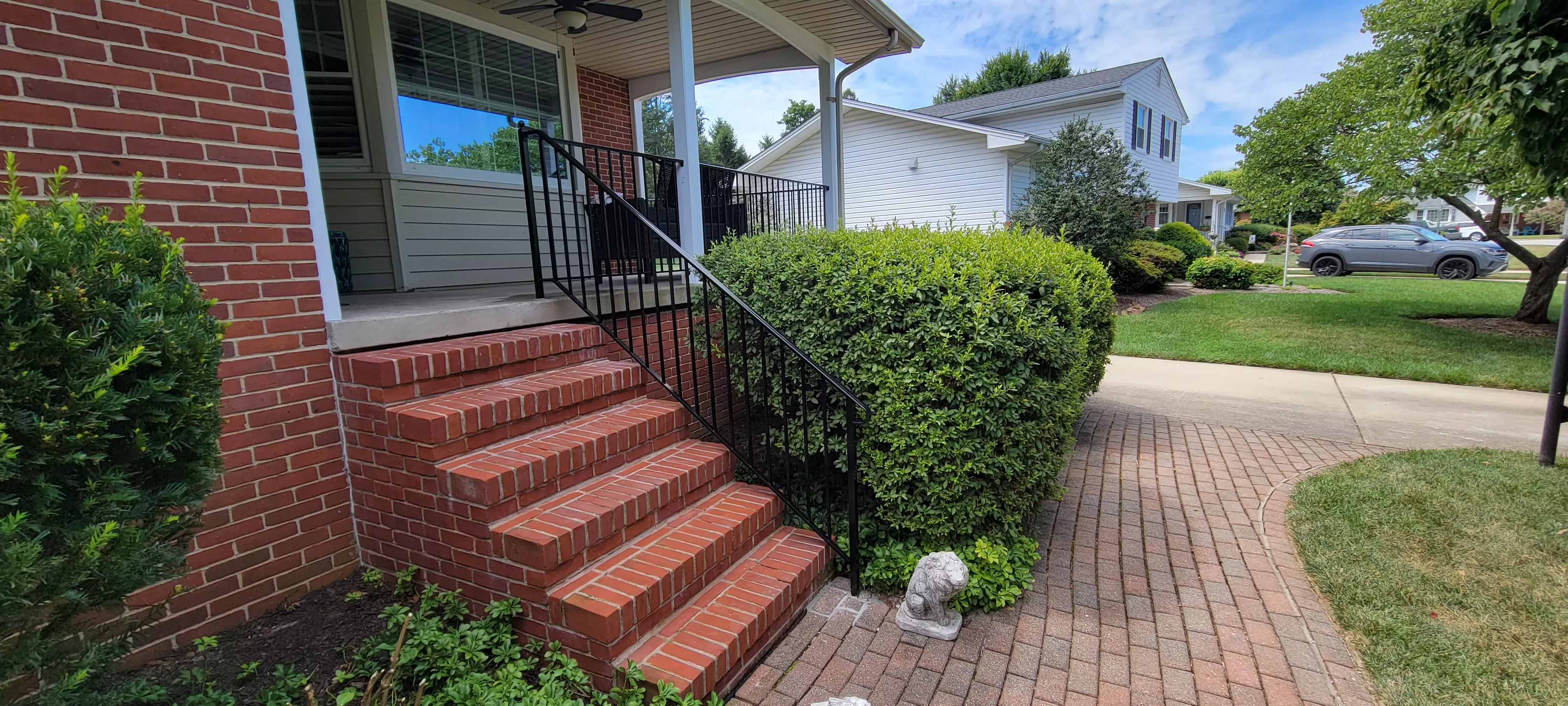 Photo of black residential railing on a brick outdoor patio and staircase