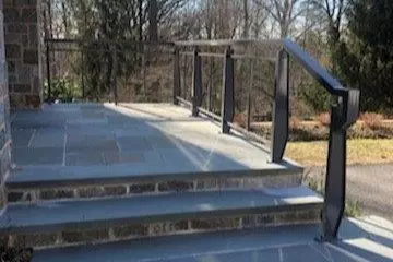 Photo of gray metal railing for outdoor stone porch and staircase