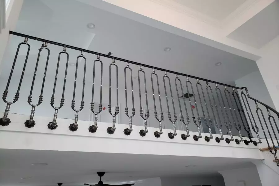 Photo of specially designed black metal railing with intricate detail focused on landing 