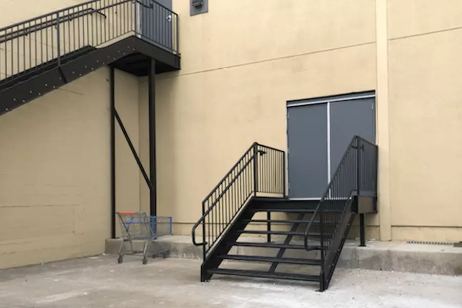Photo of two sets of black metal staircases with black railing